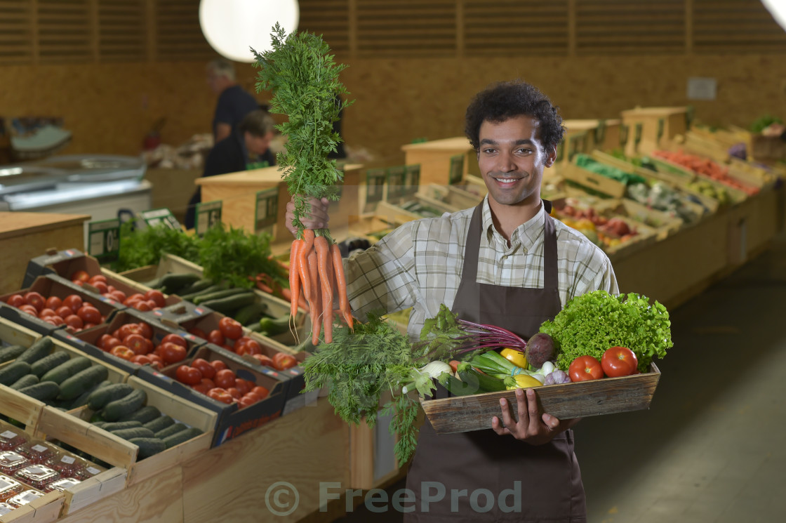 grocery clerk working in produce aisle of supermarket store produce clerk