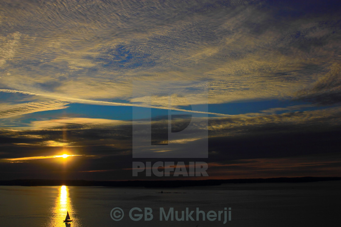 "Sailboat and Jet trail at sunset" stock image