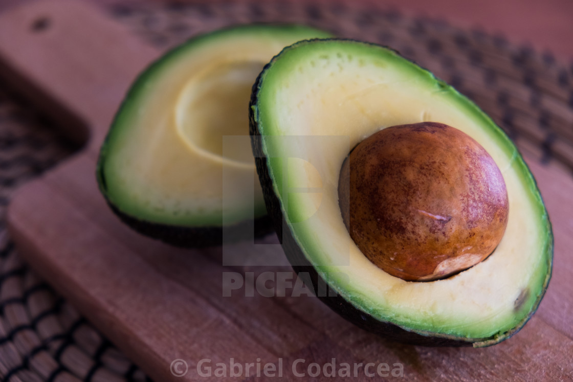 Avocado Fruit Cut In Half On Wooden Cutting Board License Download Or Print For 2 48 Photos Picfair Avocado Fruit Cut In Half On Wooden Cutting Board License Download Or Print For 2 48 Photos Picfair