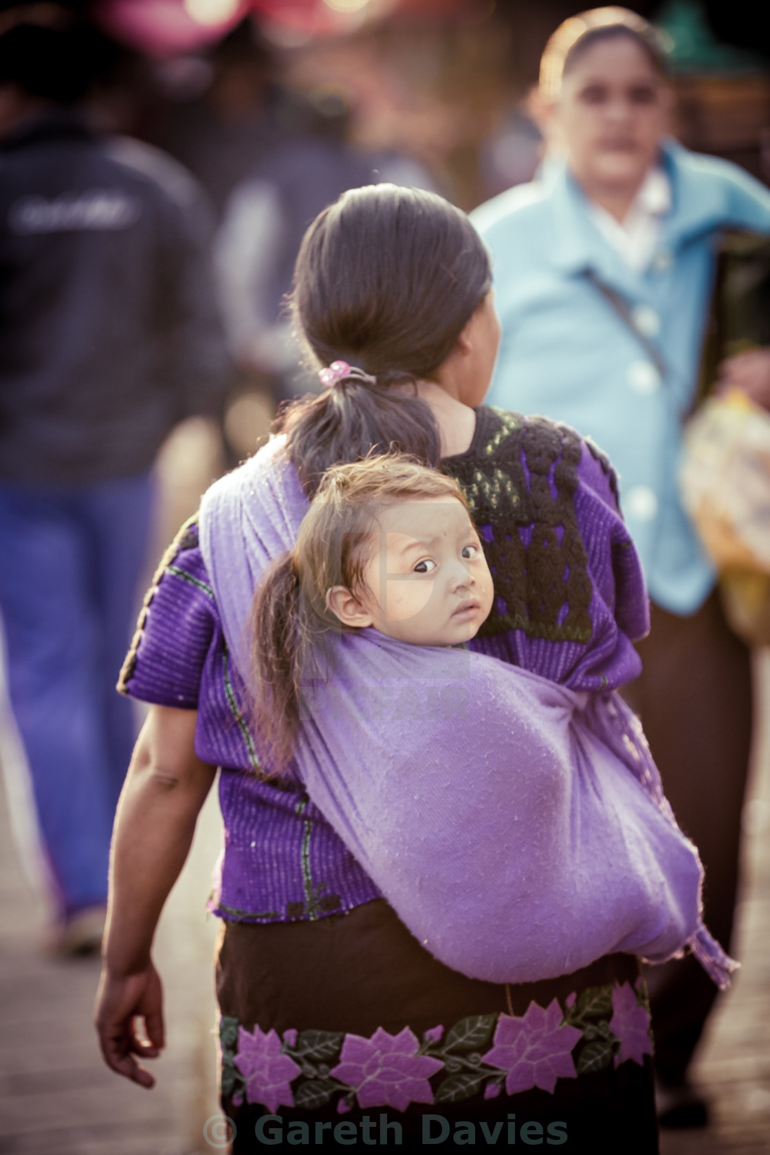 "Mexican Indigenous woman carrying her baby in a rebozo" stock image