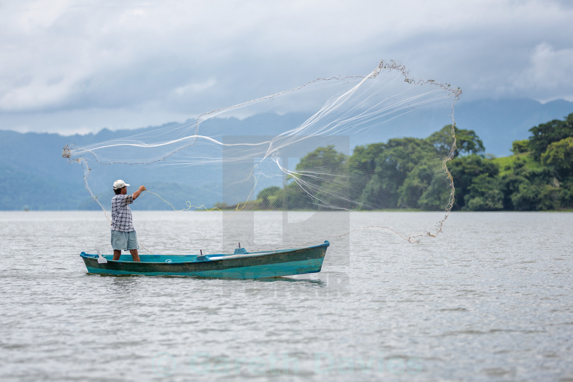 "A fisherman casts his net into a lake in catemaco, veracruz, Mexico" stock image