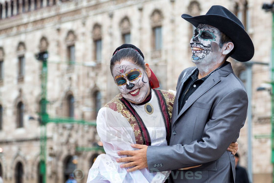 "A couple of people with their faces painted and traditional clothing for day of the dead celebrations in mexico city, mexico" stock image