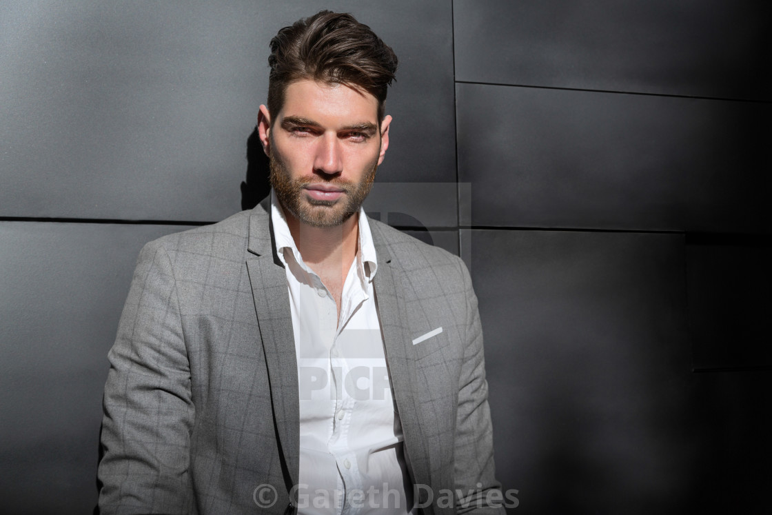 "A male fashion model standing up against a wall looking at the camera" by Gareth Davies - $77.88 "A male fashion model standing up against a wall looking at the camera" stock image