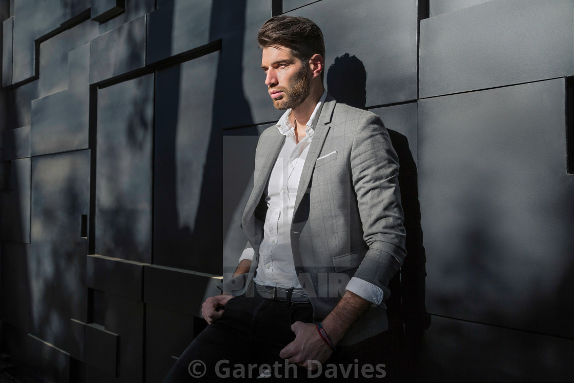 "A male fashion model standing against the wall in a grey jacket and white shirt" by Gareth Davies - $77.88 "A male fashion model standing against the wall in a grey jacket and white shirt" stock image