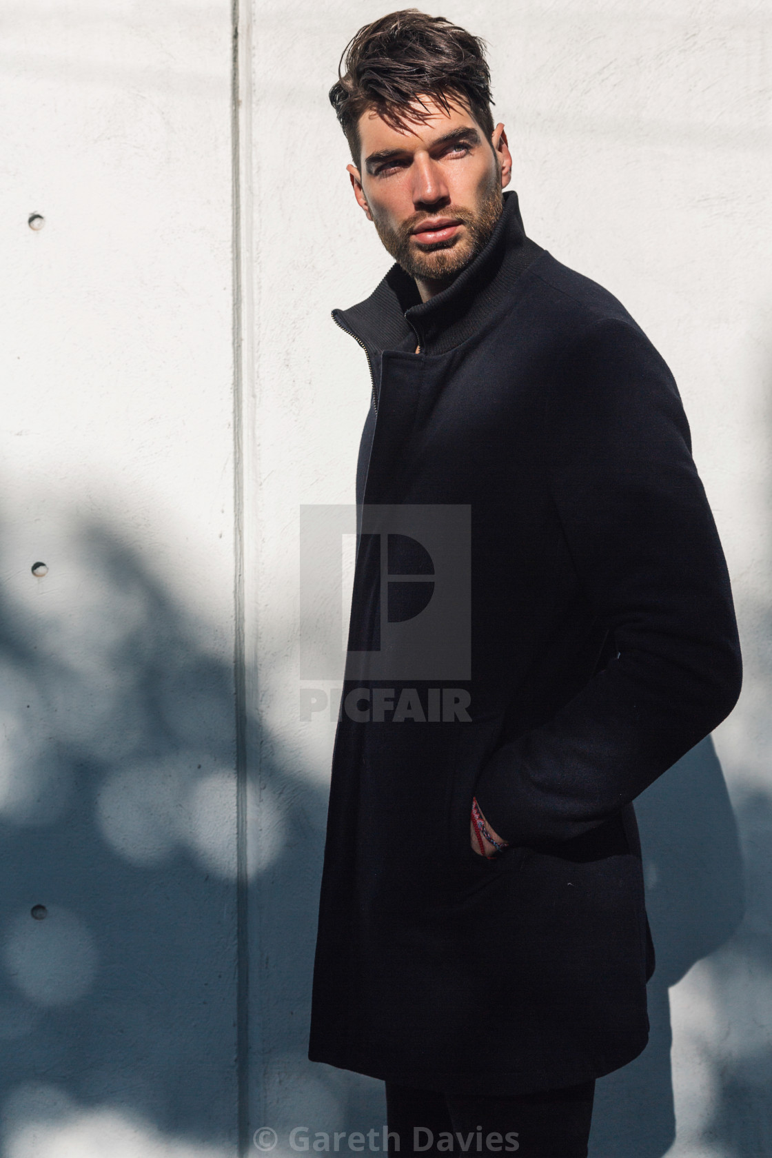 "Male Fashion model in long black coat" by Gareth Davies - $77.88 "Male Fashion model in long black coat" stock image