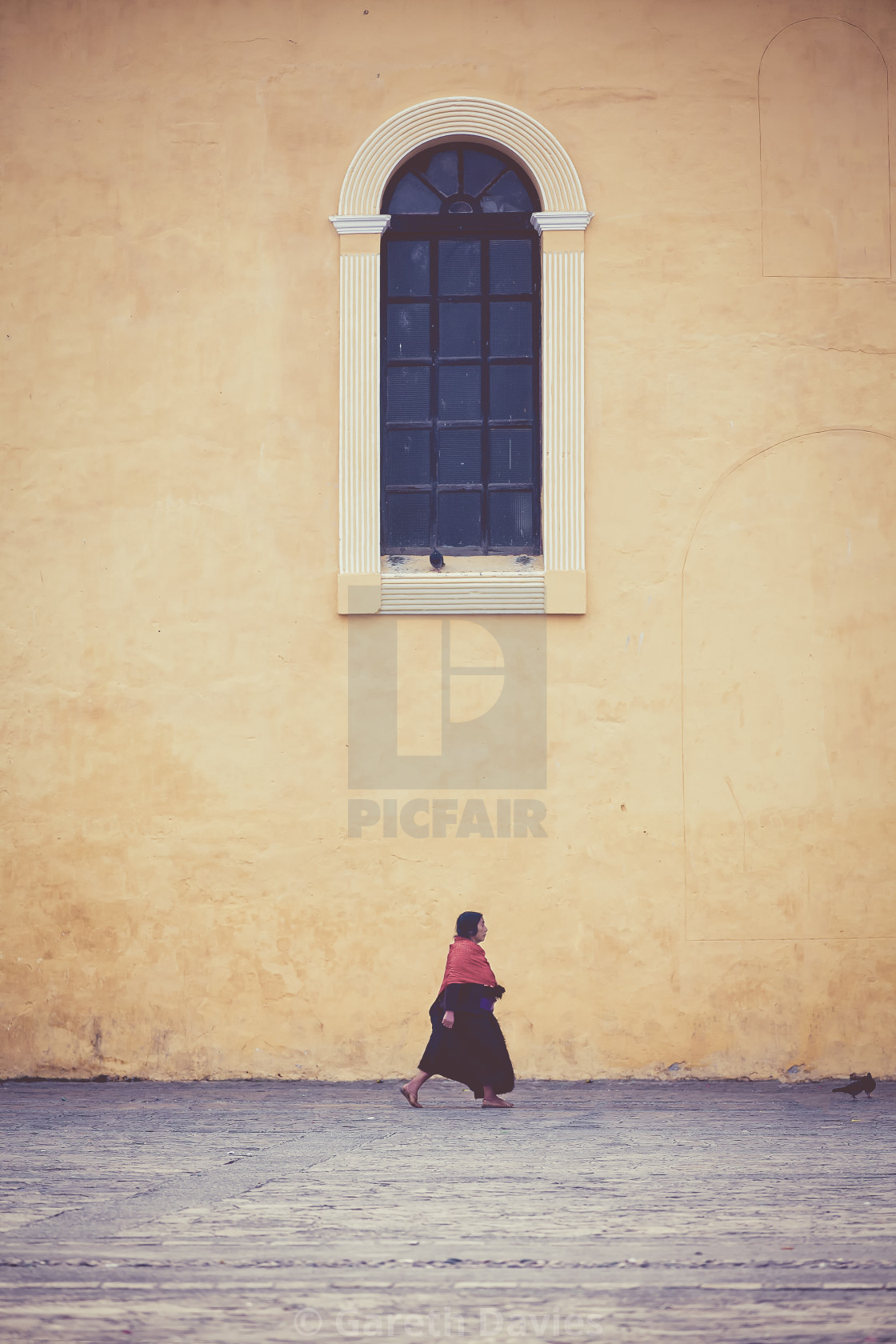 "A woman walking under a window in mexico" by Gareth Davies - $7.79 "A woman walking under a window in mexico" stock image