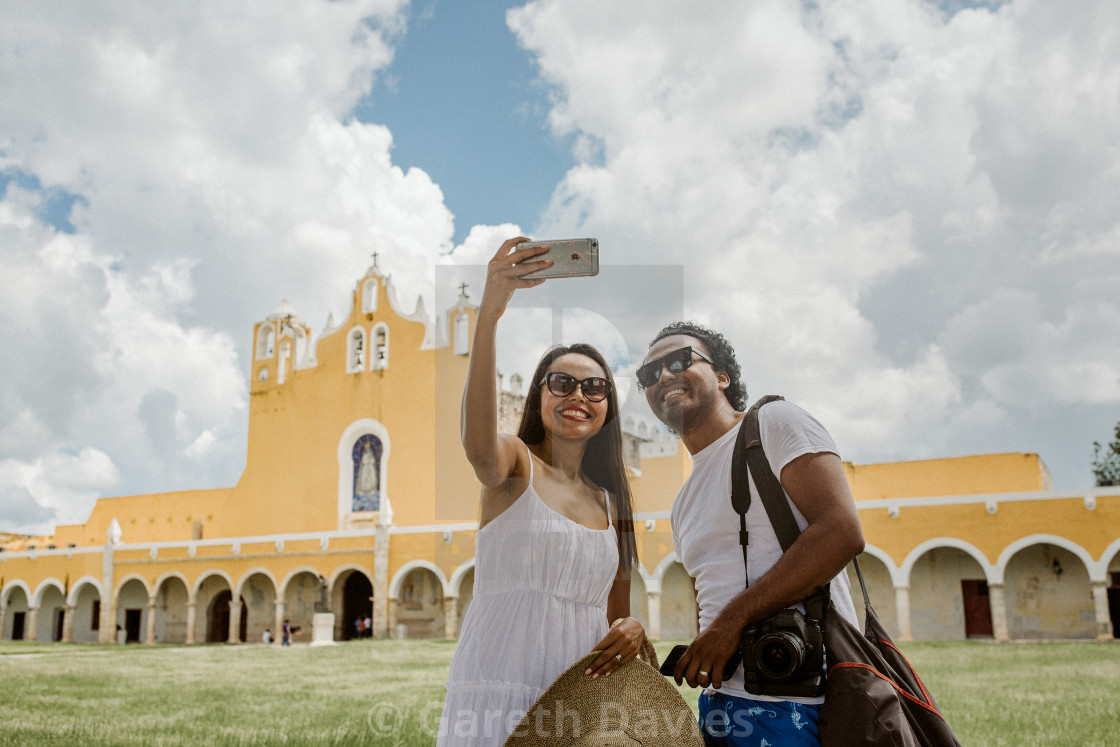"two people take a selfie in front of a mexican monastery in yucatan" by Gareth Davies - $15.58 "two people take a selfie in front of a mexican monastery in yucatan" stock image