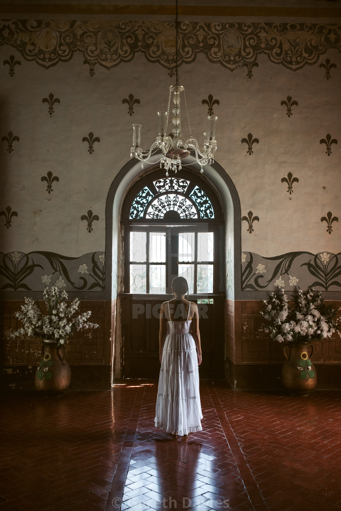 "A lady in a white dress stands facing an old colonial doorway in a colonial building" by Gareth Davies - $15.58 "A lady in a white dress stands facing an old colonial doorway in a colonial building" stock image