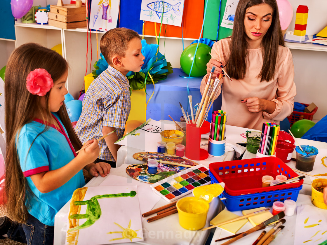 Children Painting And Drawing Together Craft Lesson In Primary