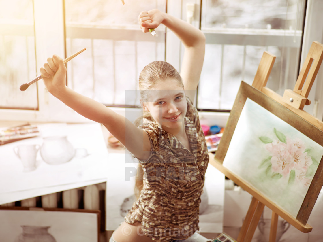 Artist Painting On Easel In Studio Girl Paints With Brush