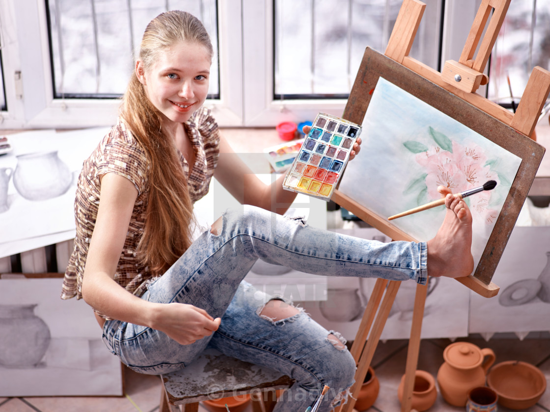 Artist Painting On Easel In Studio Girl Paints With Brush