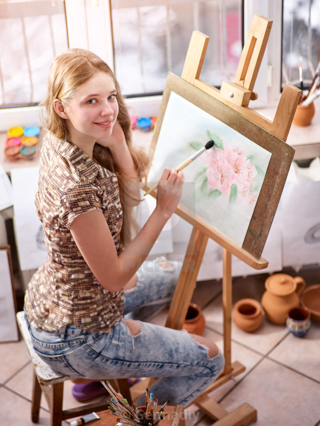 Artist Painting On Easel In Studio Girl Paints With Brush