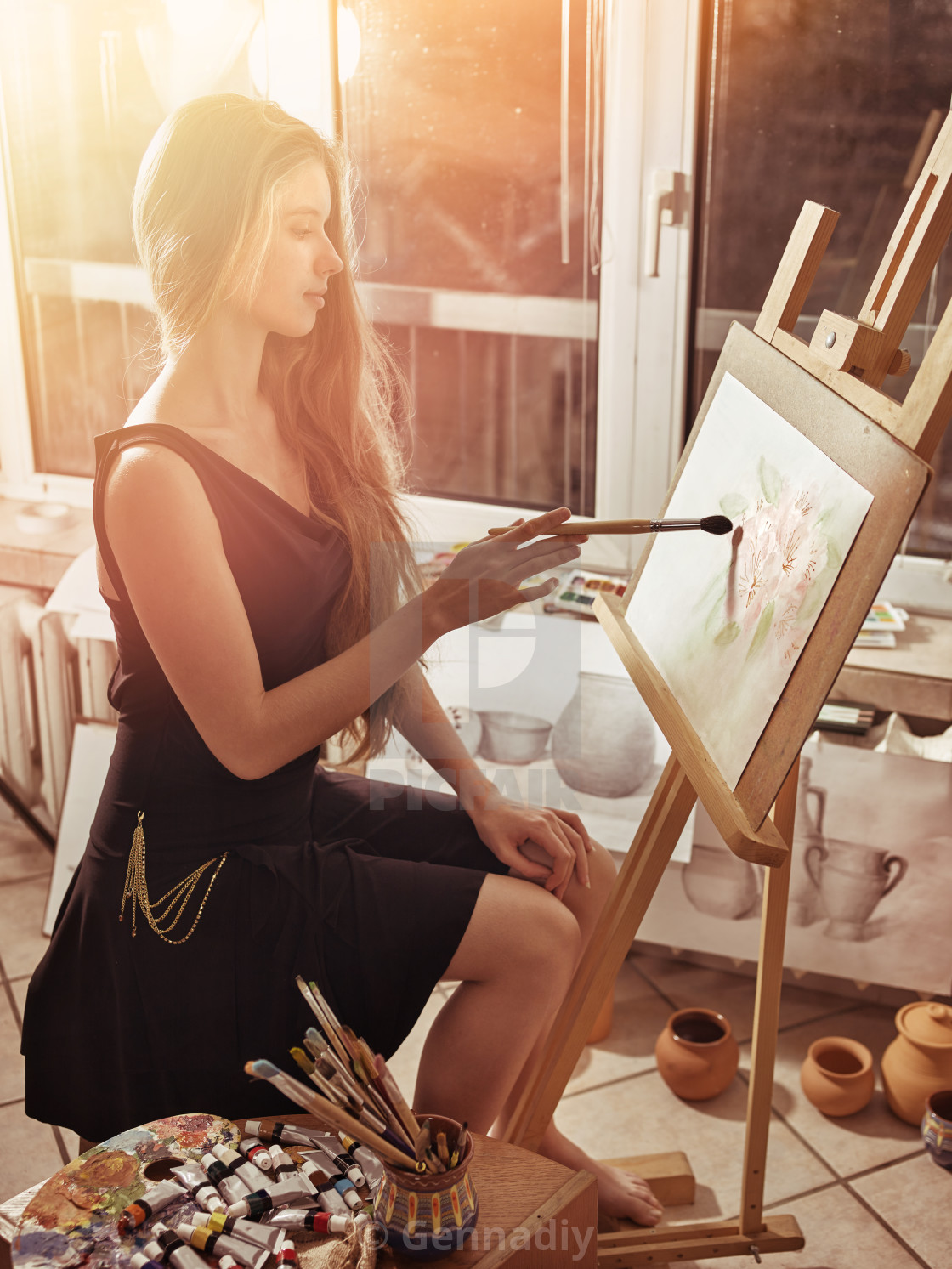 Artist Painting On Easel In Studio Girl Paints With Brush
