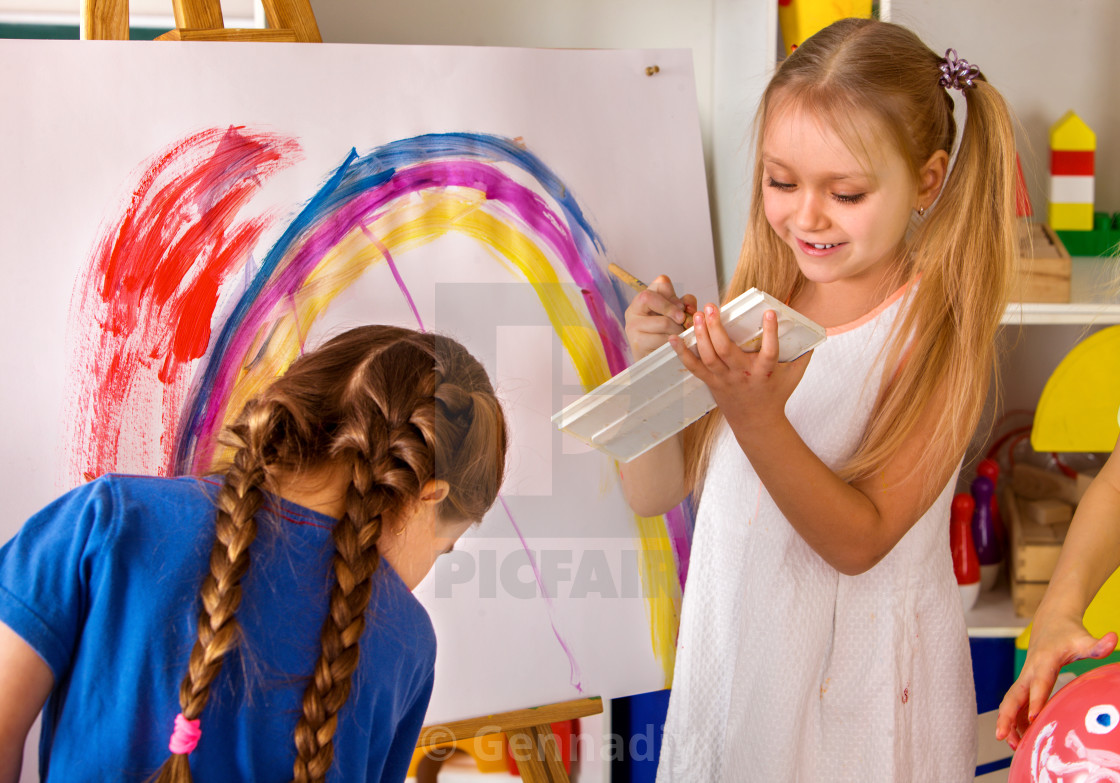 Children Painting Finger On Easel Group Of Kids With Teacher