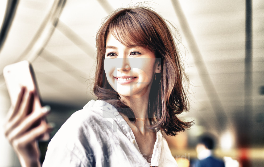 Beautiful Japanese Woman Looking At Smartphone Inside Subway Station License Download Or Print For 6 Photos Picfair