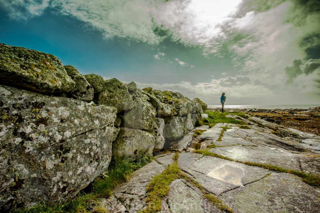 "solitary figure in rocky landscape." stock image