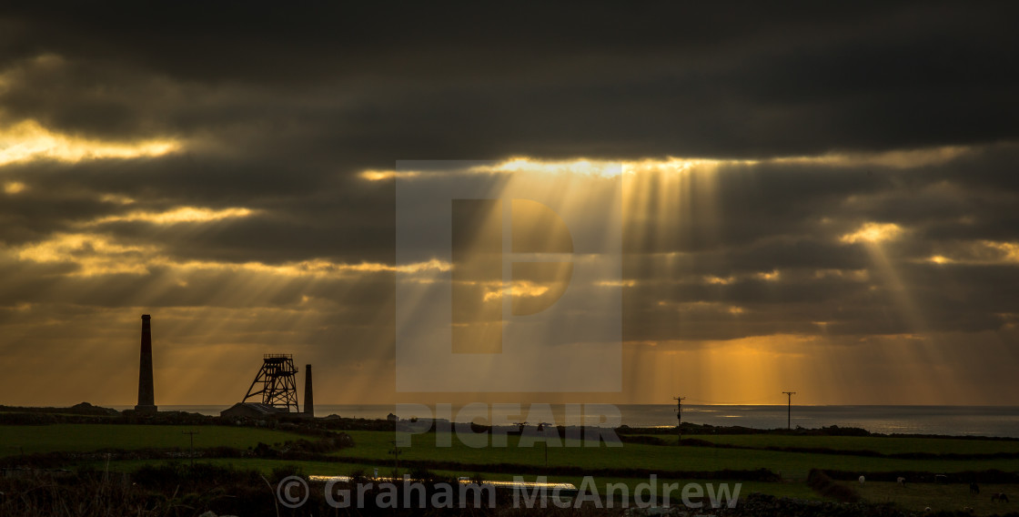 "Sun rays over Cornish tin mine" stock image