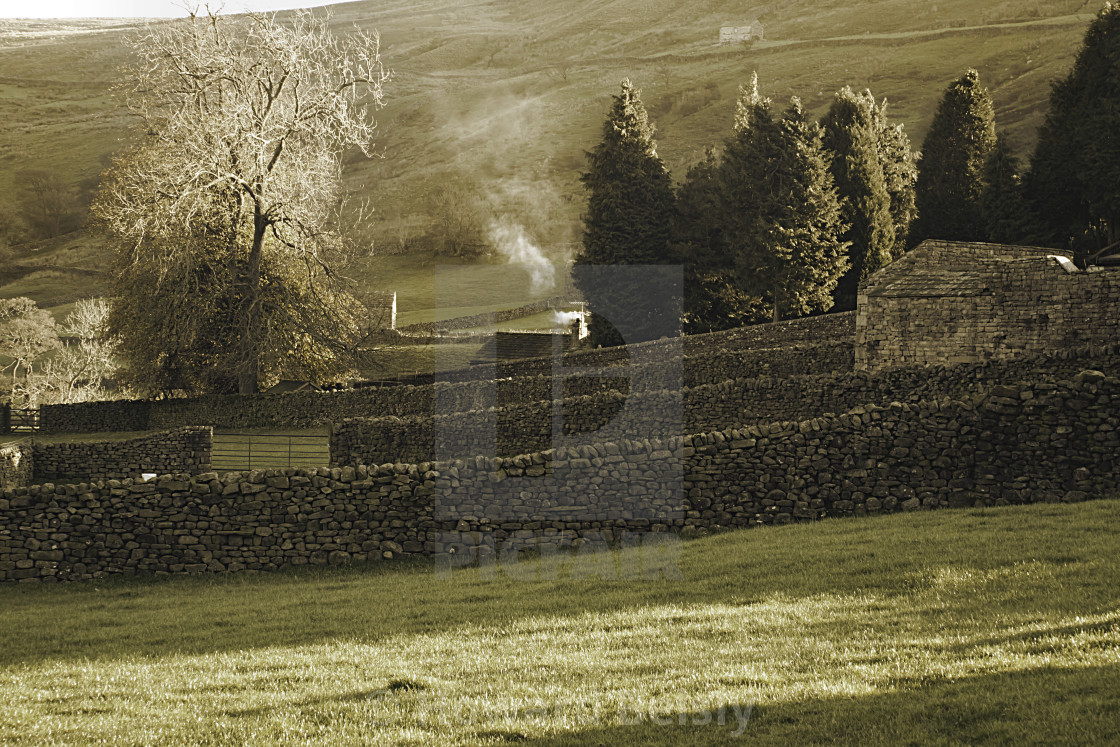 "Smoke rising in the sunlight in Muker, Swaledale" stock image