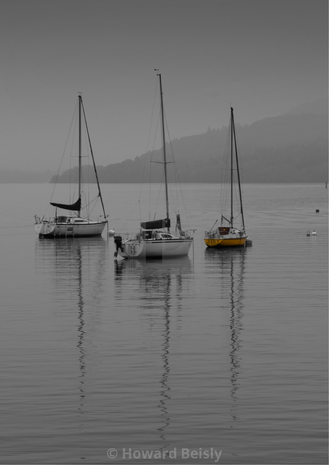 "Three yachts on the lake, seen on a grey day with a touch of colour" stock image