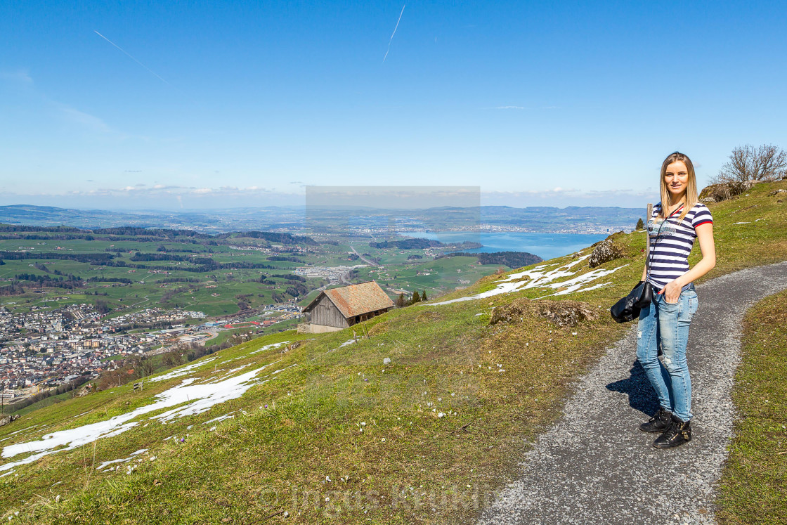 "Beautiful nature view in mountains in Switzerland. Beautiful girl hiking in..." stock image