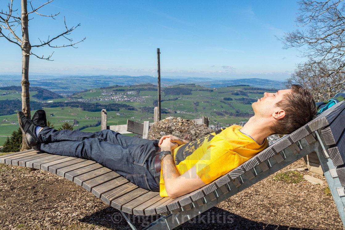 "Young man relaxing in the nature. Beautiful nature view in Switzerland." stock image