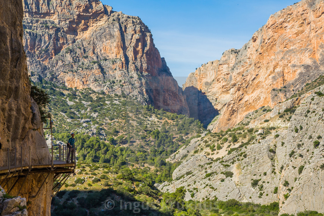 "Young man standing on the edge of the cliff path in one of the most beautiful..." stock image