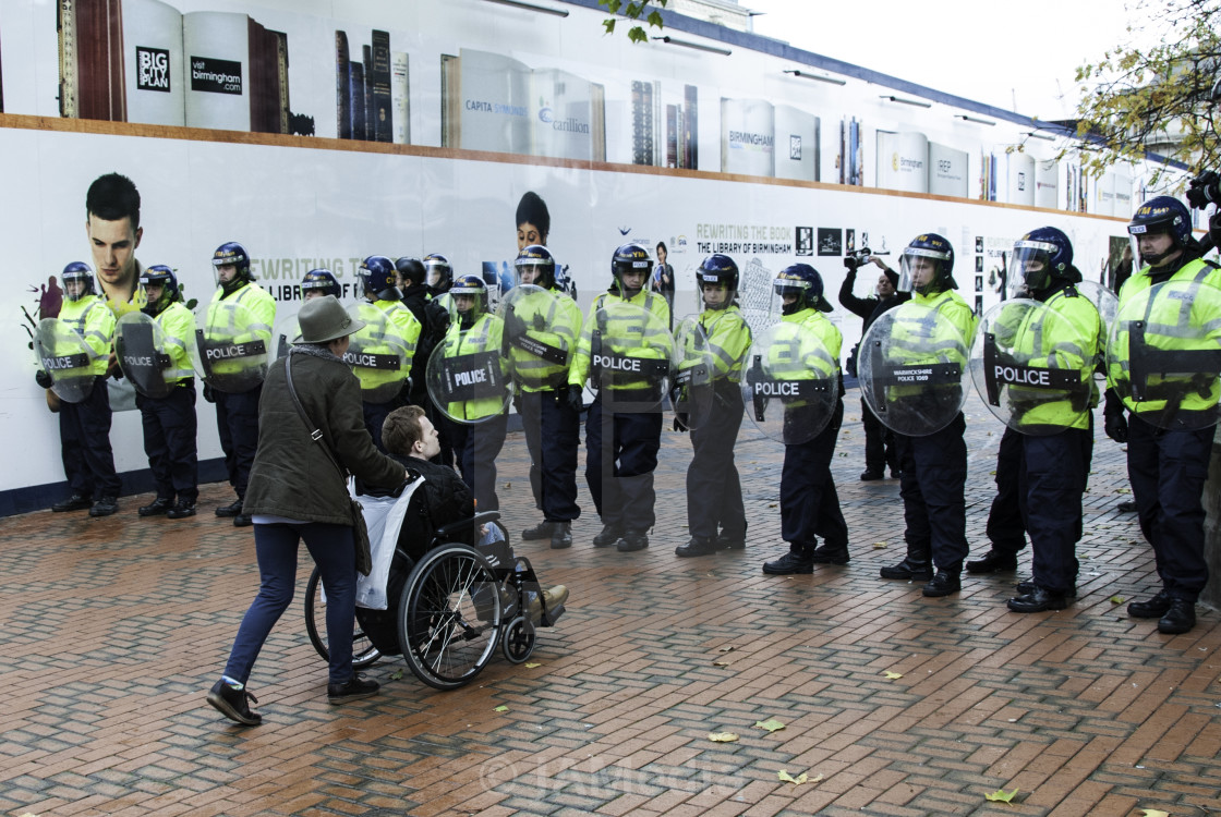 "Wheel Chair and Riot Police" stock image