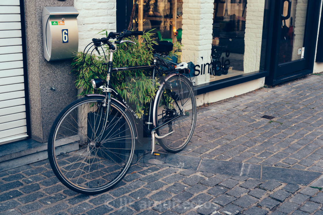 "Bicycle parked in a shop in Mechelen" stock image