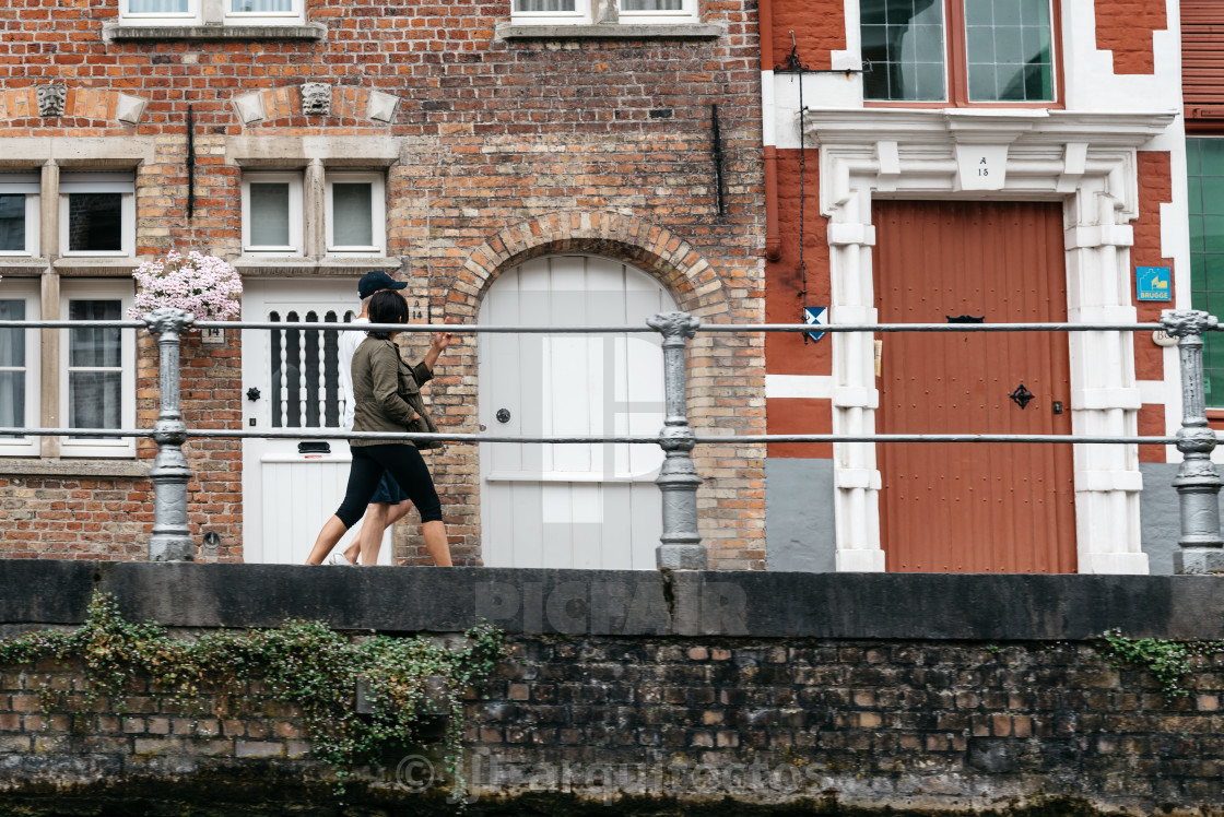 "People walking by the Canal in the medieval city of Bruges" stock image