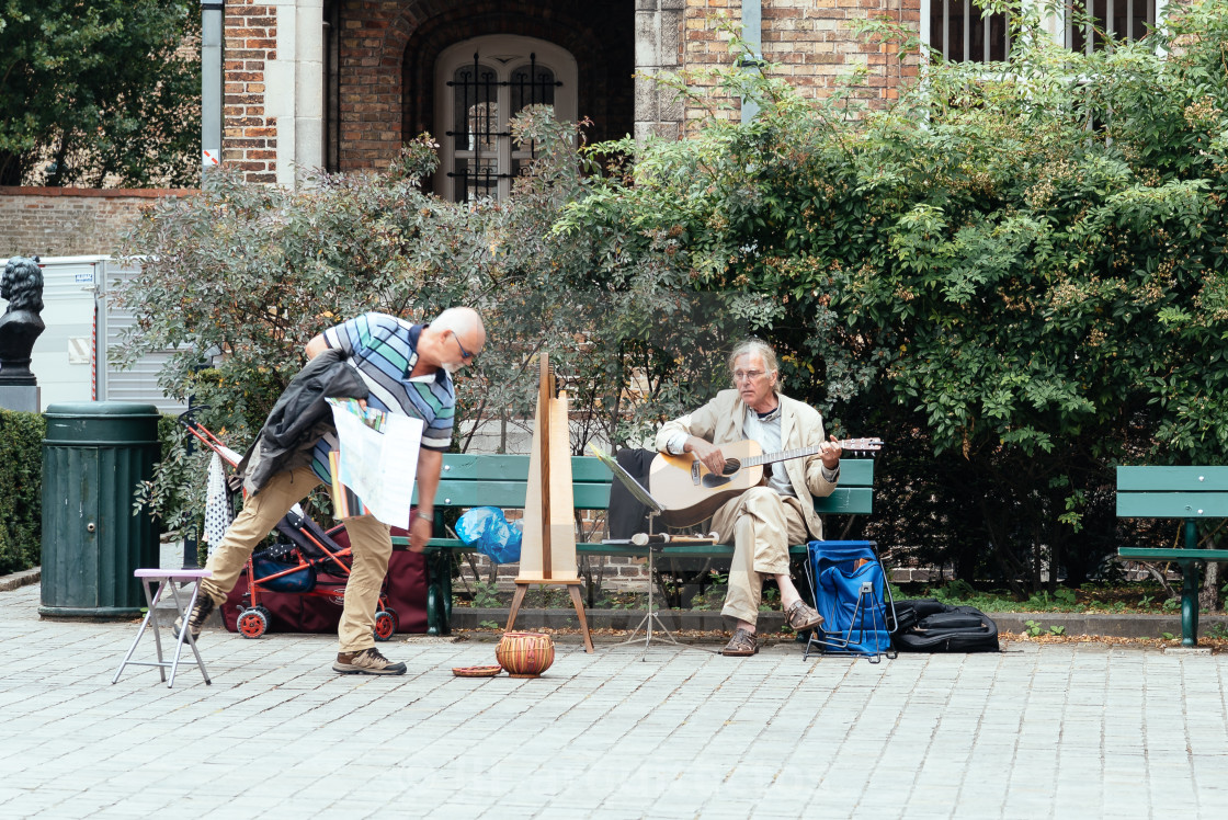 "Musician playing guitar and harp in the streets of Bruges" stock image