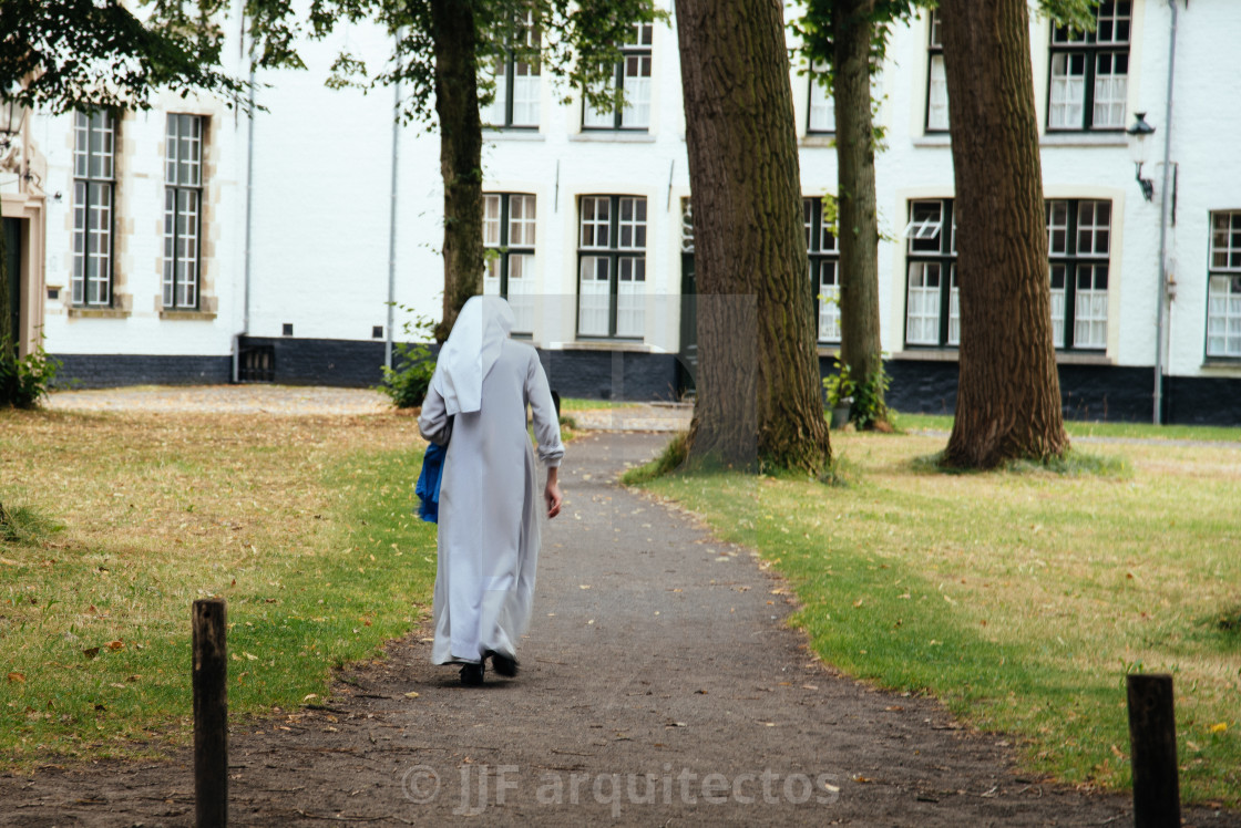 "Nun walking on the park" stock image