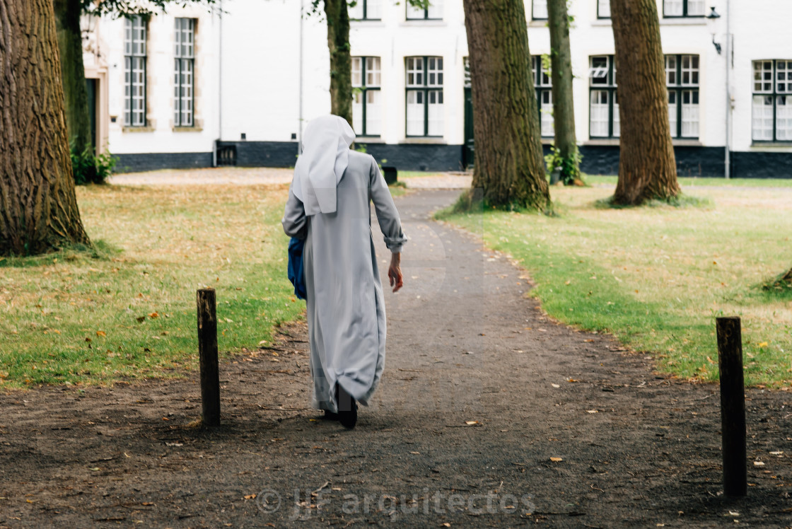 "Nun walking on the park" stock image