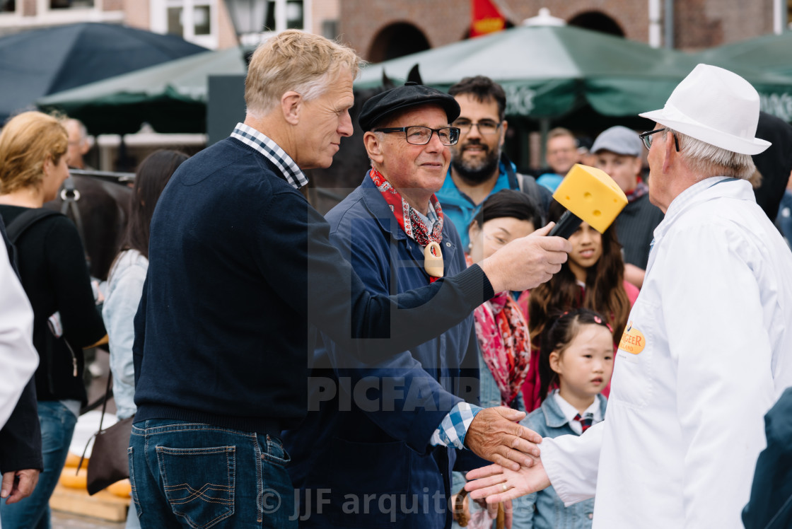 "Traditional producers in Gouda Cheese Market a rainy day" stock image