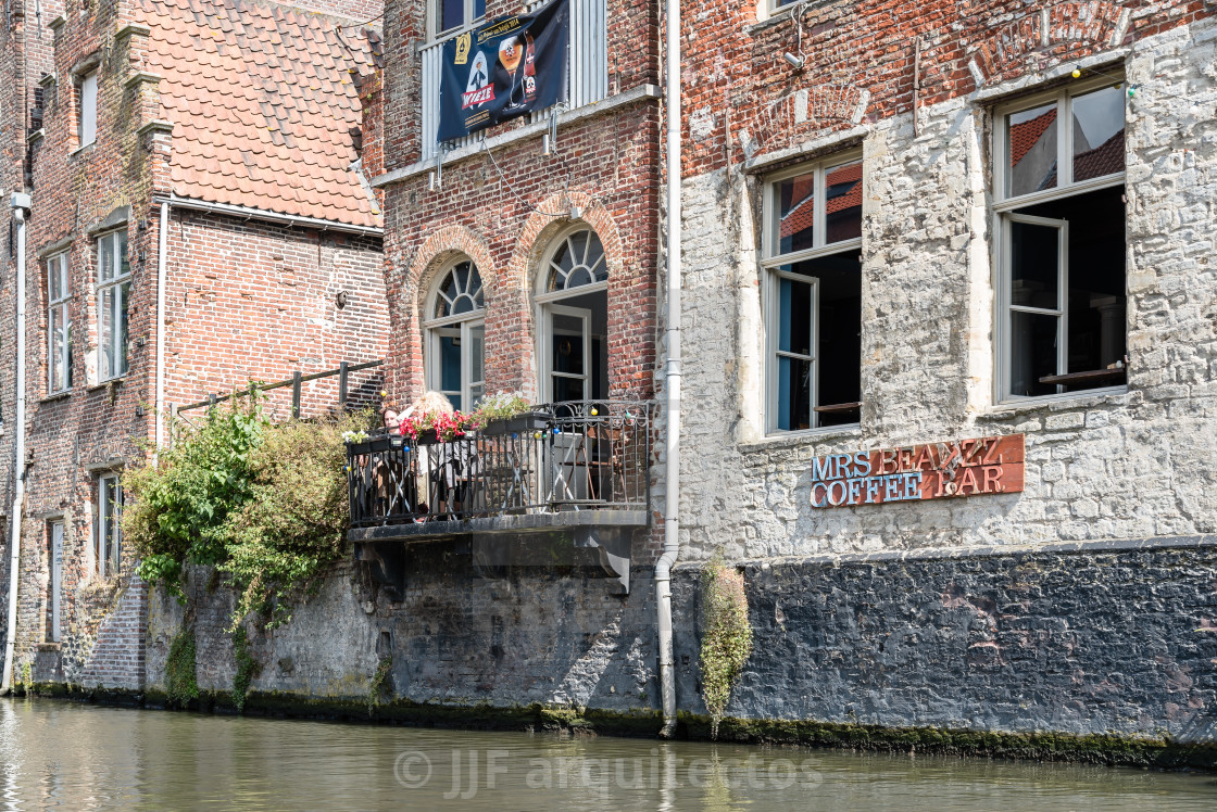 "People sitting on a restaurant terrace in Embankment Graslei in" stock image