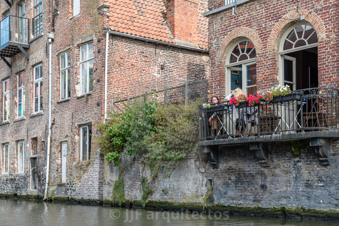 "People sitting on a restaurant terrace in Embankment Graslei in" stock image