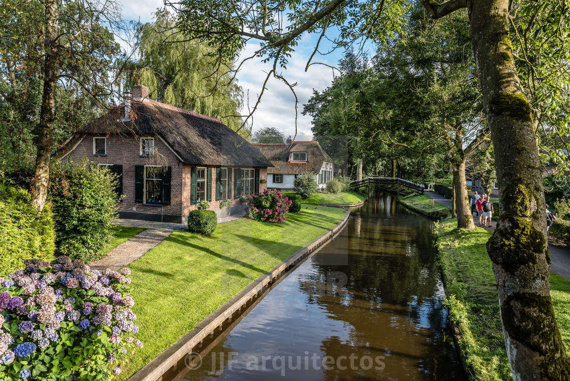 "Waterway and cottage in village in the Netherlands" stock image