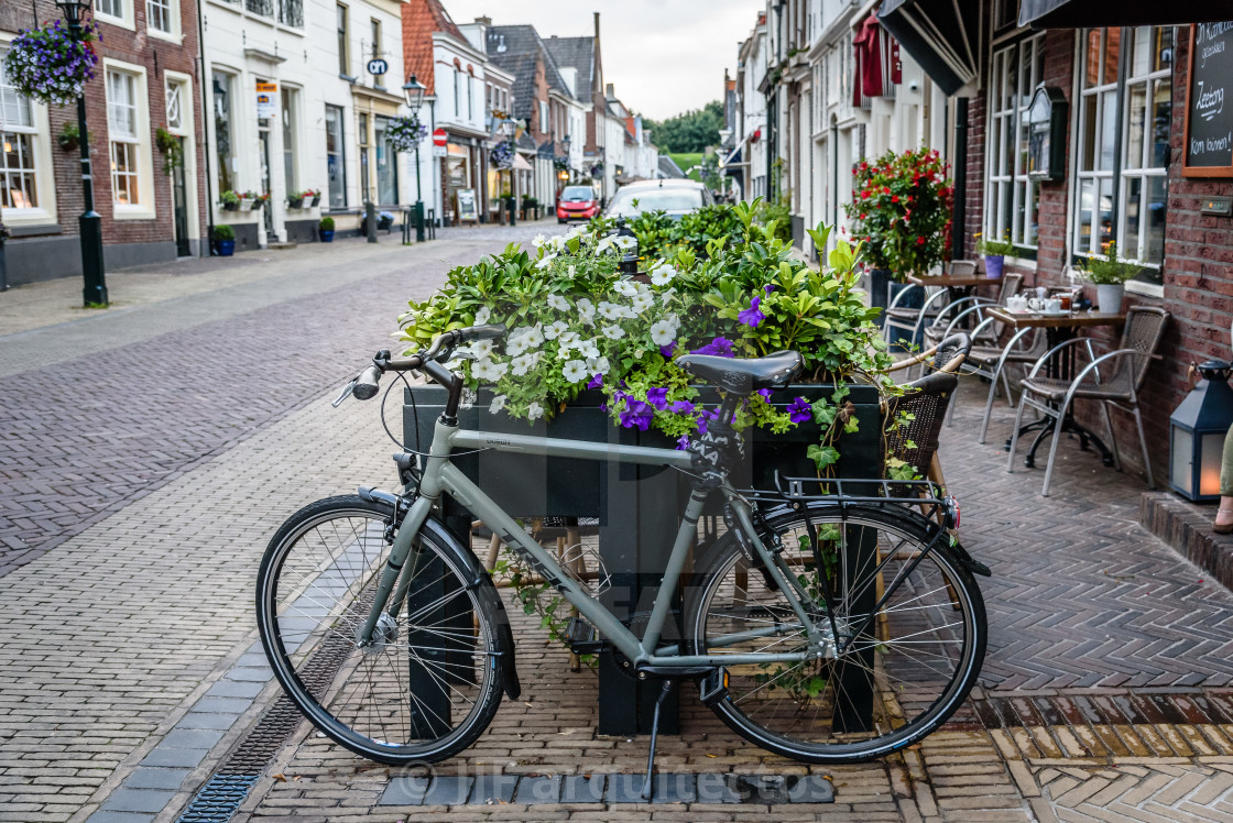 "Picturesque street and bicycle in old city of Naarden at sunset" stock image