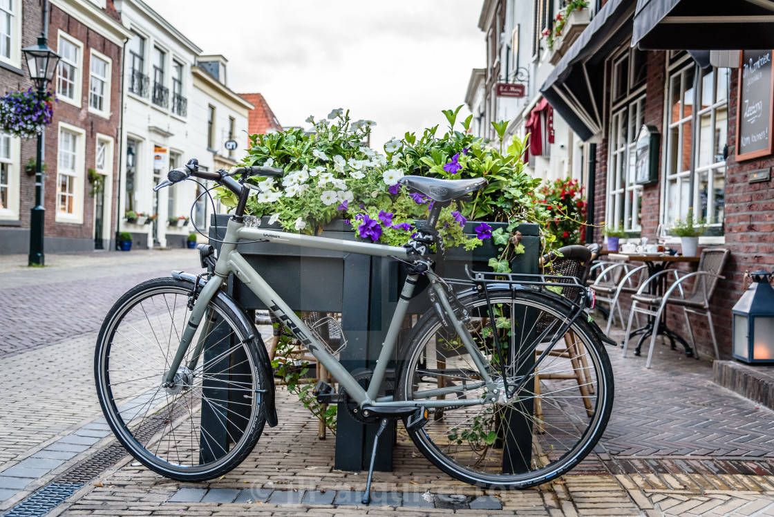 "Picturesque street and bicycle in old city of Naarden at sunset" stock image