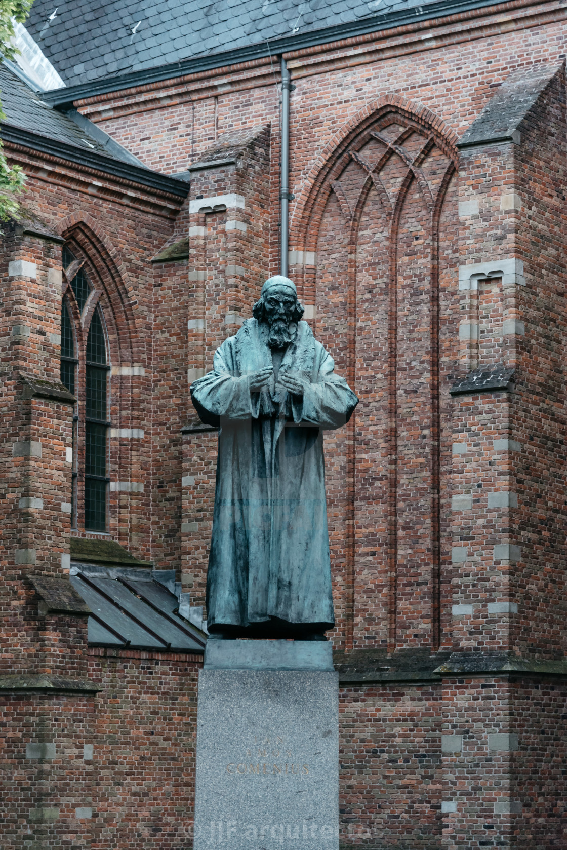 "Grote Kerk and bronze statue in the old city of Naarden at sunse" stock image