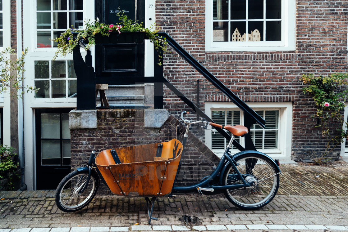 "Old vintage bicycle parked in front of house in Amsterdam" stock image