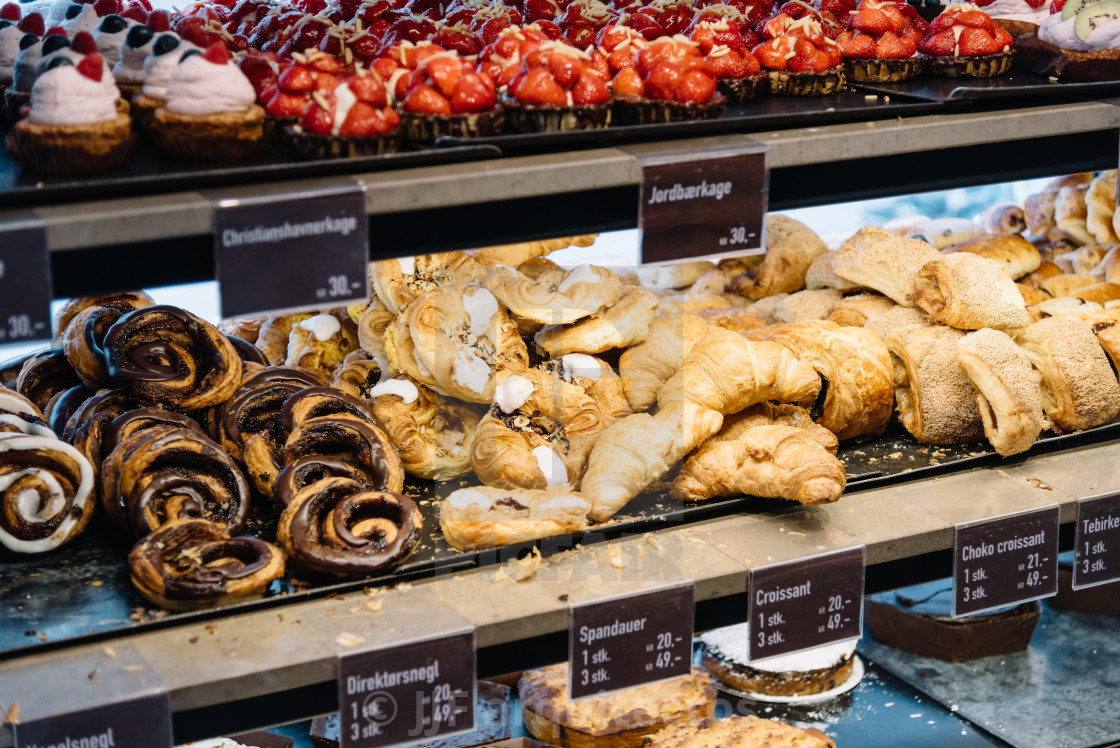 "Cinnamon Danish swirls, croissants and other pastry in cafe" stock image