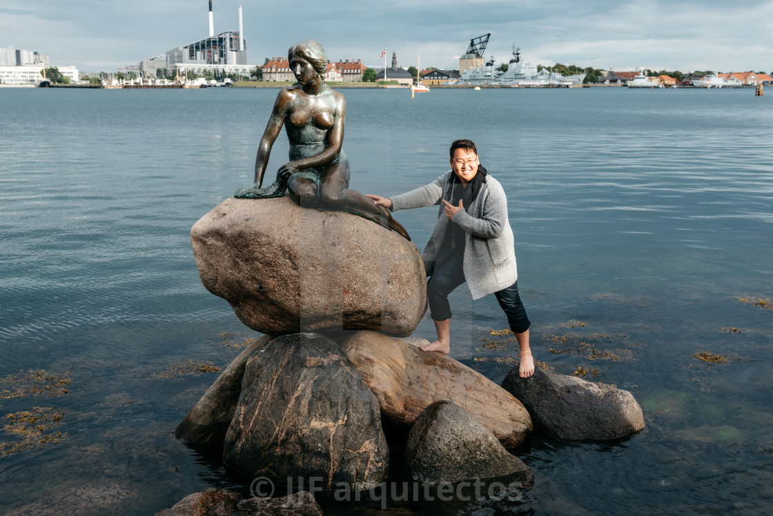 "Some unidentified tourists trying to climb to little mermaid sta" stock image