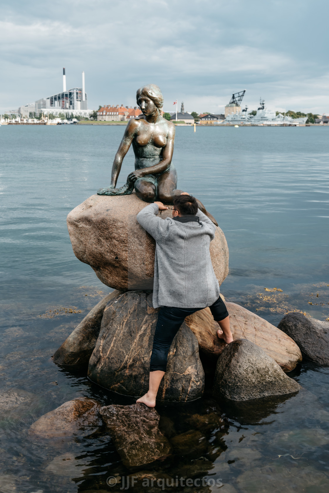 "Some unidentified tourists trying to climb to little mermaid sta" stock image