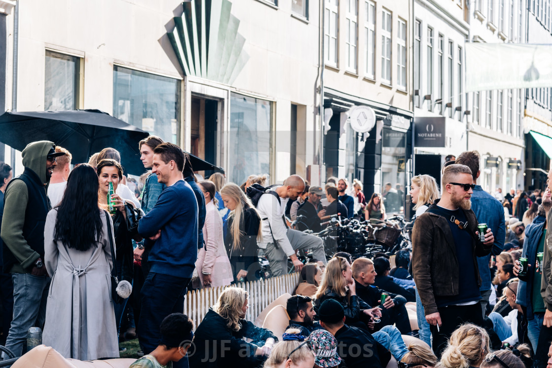 "Crowd of young people sitting and enjoying in Kronprinsensgade," stock image