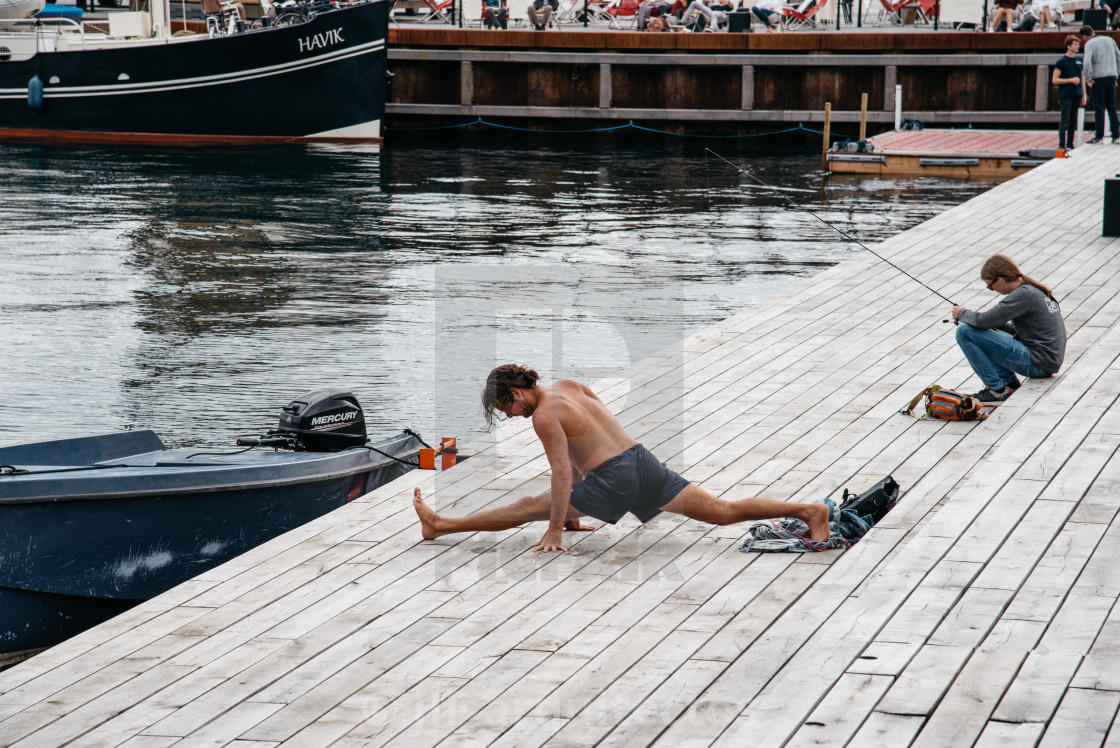 "Man practicing yoga outdoors in the pier of the harbor of Copenh" stock image