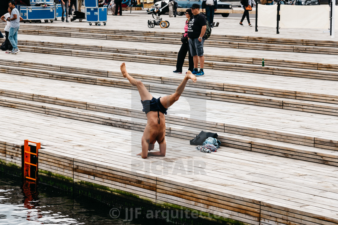 "Man practicing yoga outdoors in the pier of the harbor of Copenh" stock image