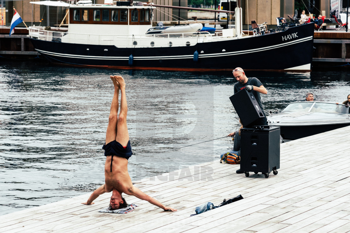 "Man practicing yoga outdoors in the pier of the harbor of Copenh" stock image