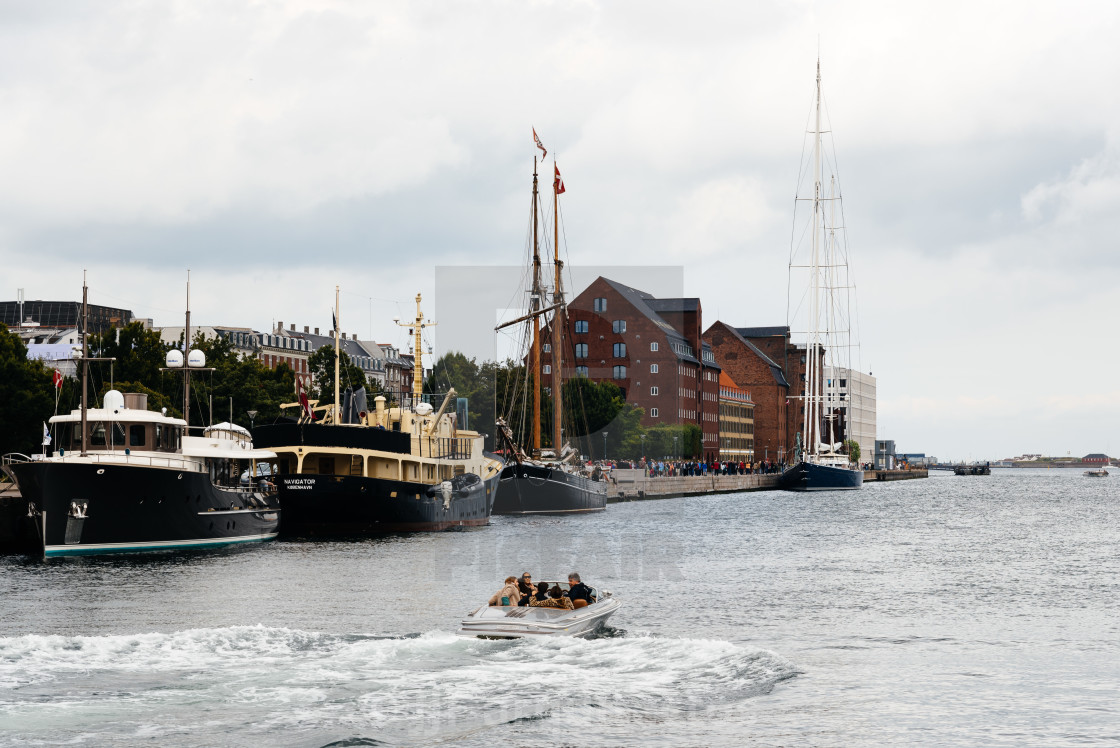 "Boat with tourists on Copenhagen's harbor surrounded by moored" stock image