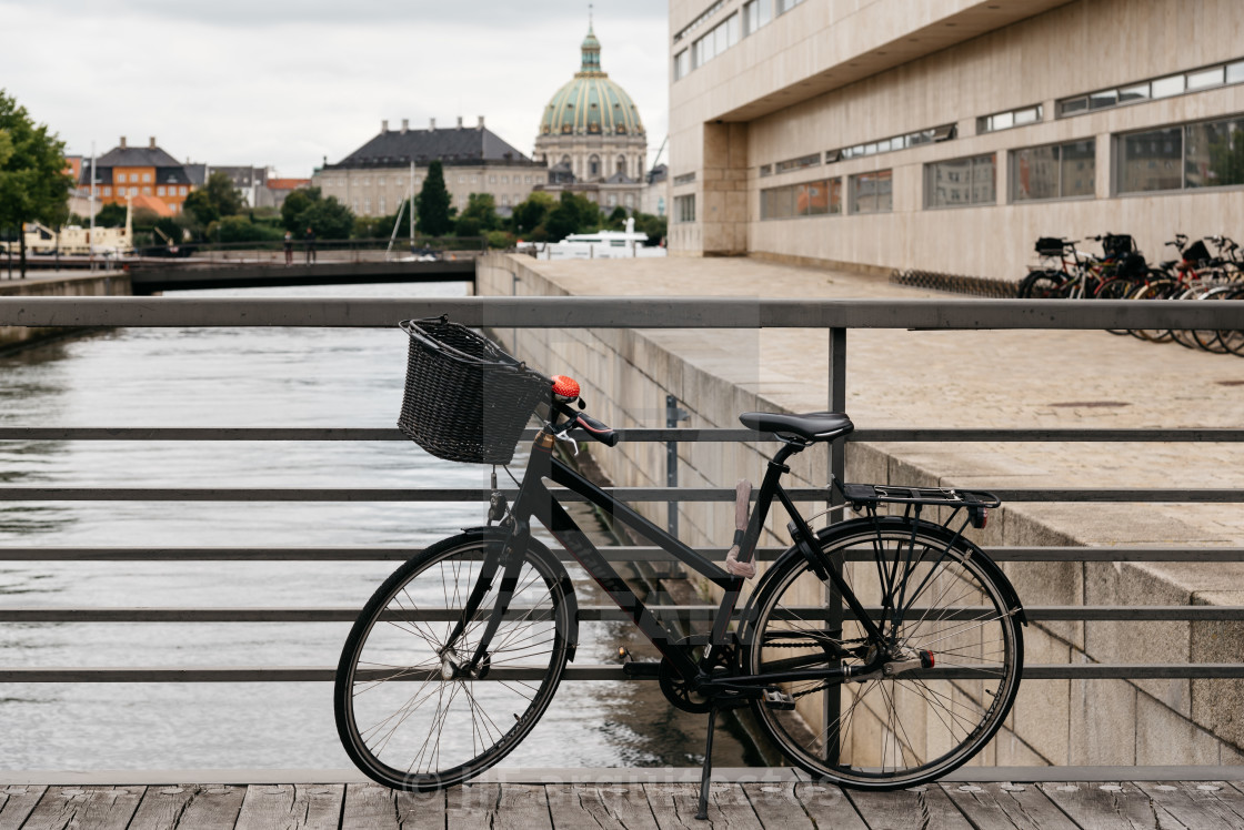 "Bicycle parked on a bridge against old Copenhagen cityscape" stock image