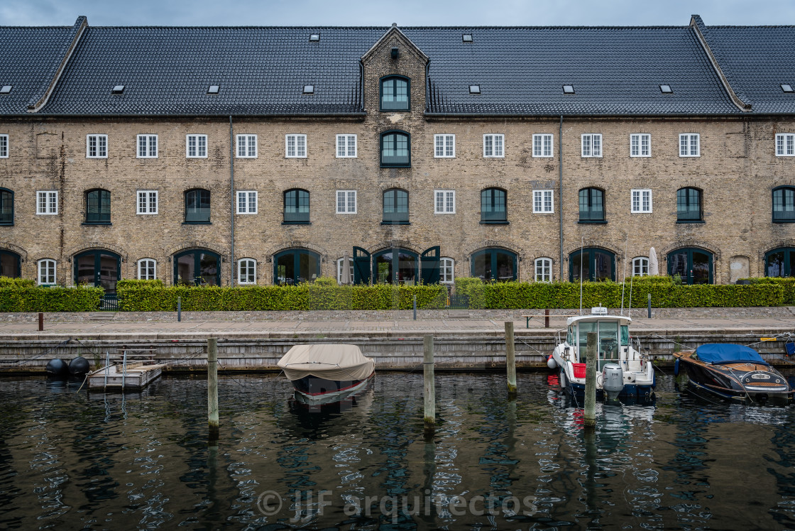 "Port of Copenhagen with boats against old building a cloudy summ" stock image